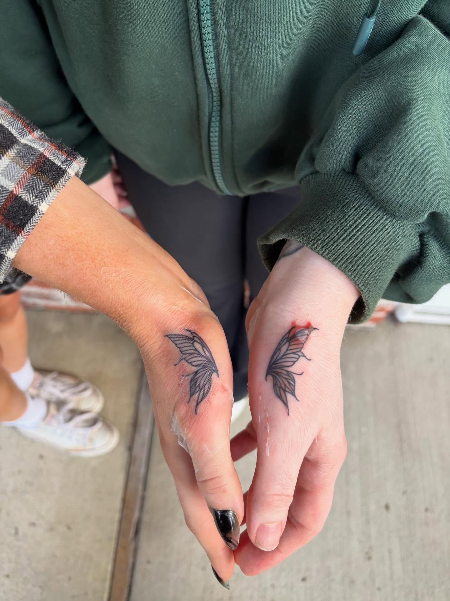 Butterfly black and grey tattoo on the hand by Malia Clark