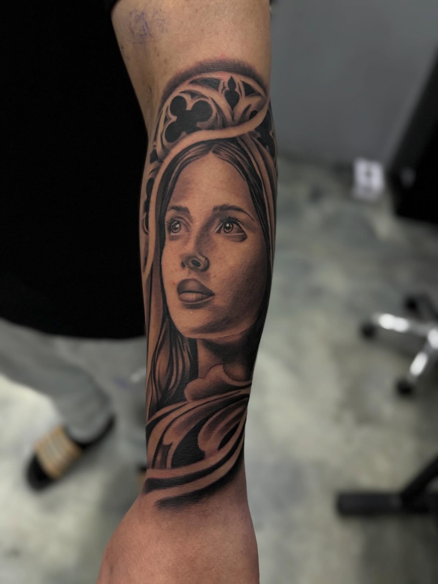 Portrait realism tattoo on the forearm by Devin
