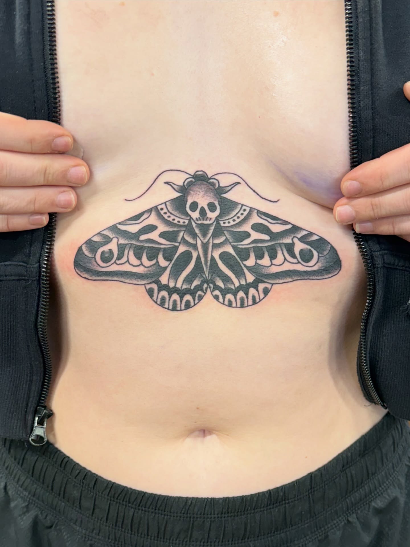 Moth black and grey tattoo on the torso by Aaron ulfstam