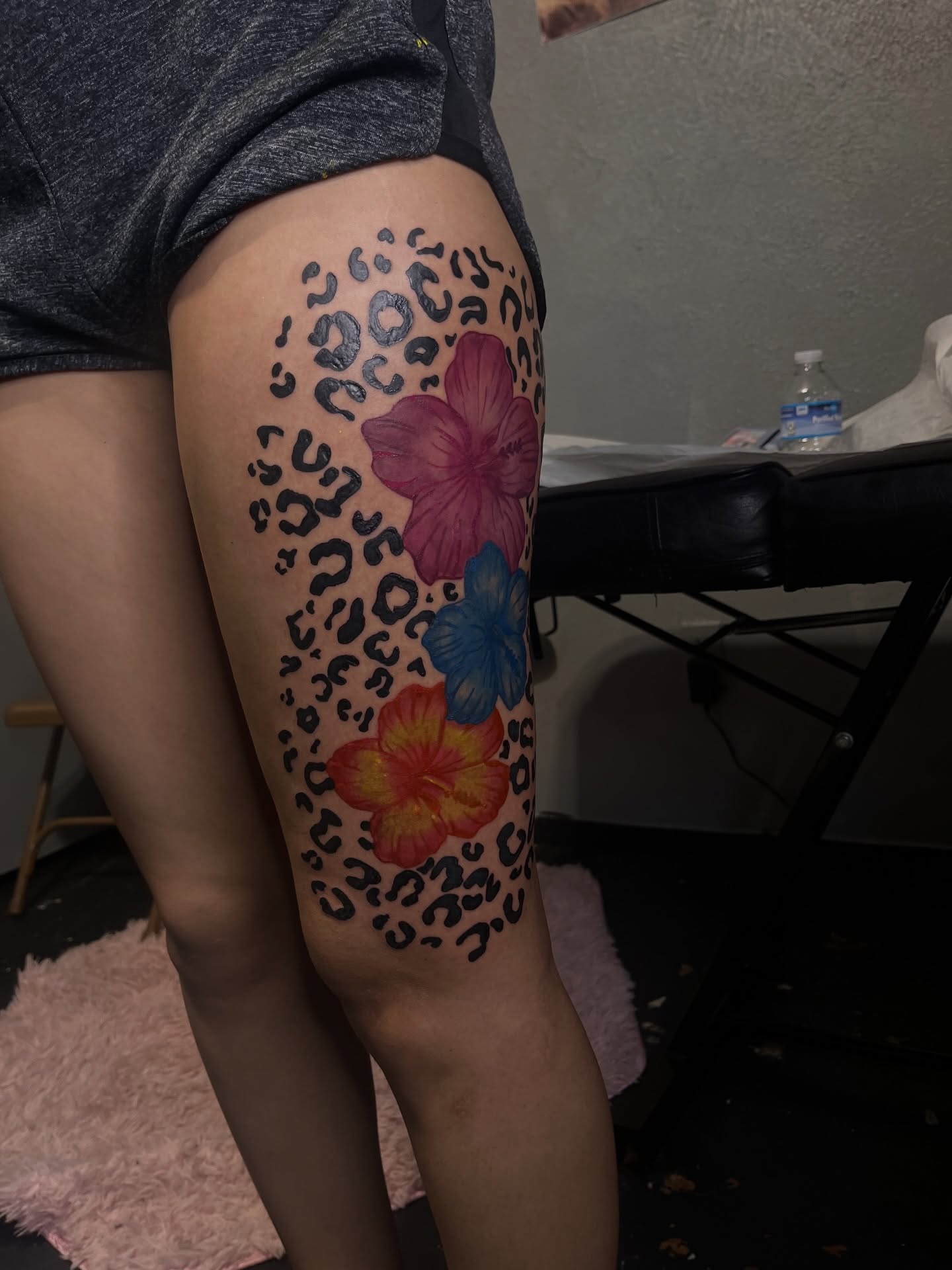 Leopard print and flowers new school tattoo on the thigh by The inspo
