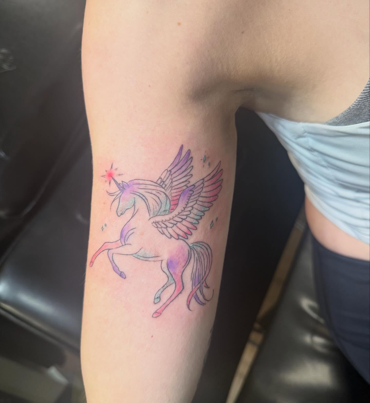 Unicorns watercolor tattoo on the forearm by Eric Garcia