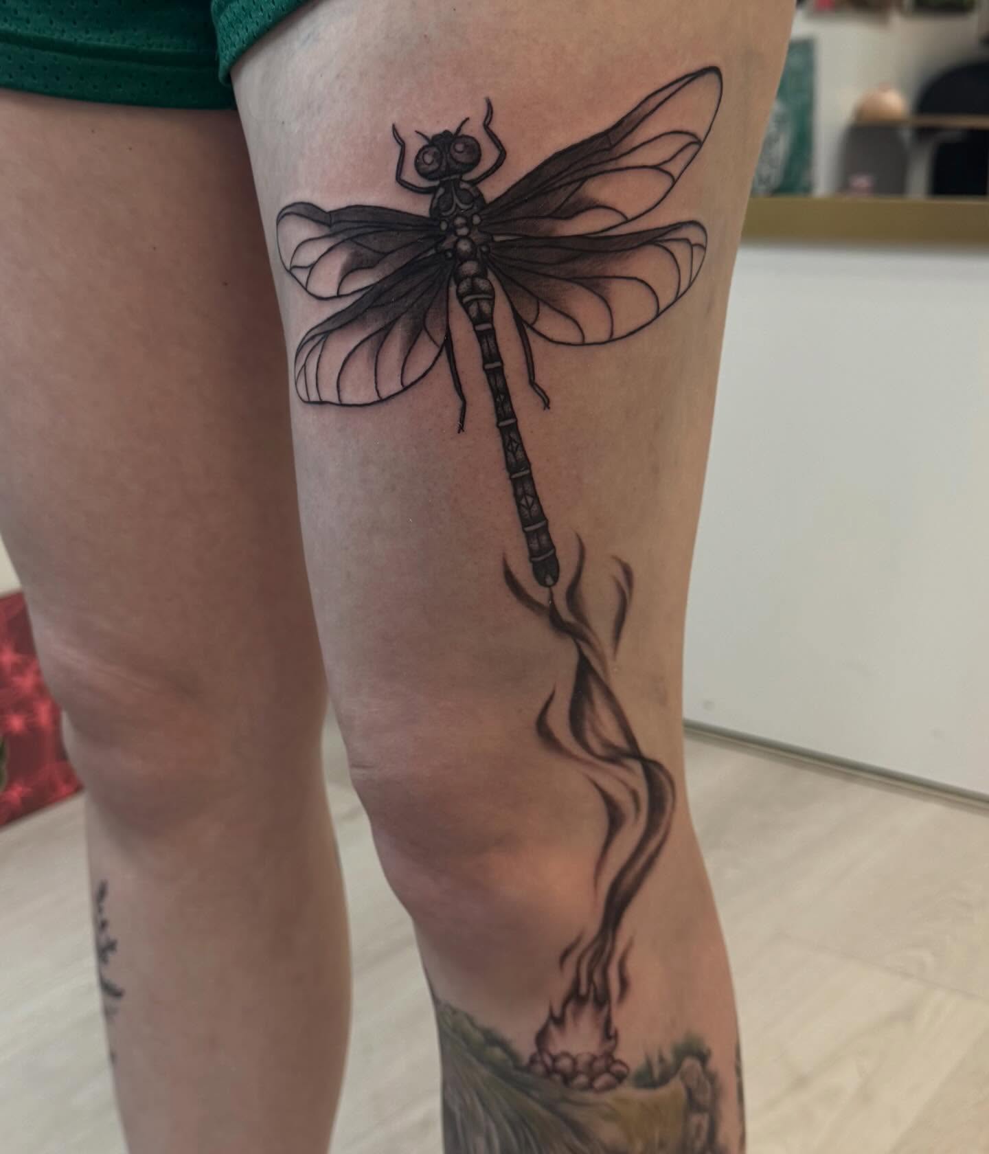 Dragonfly black and grey tattoo on the thigh by Gigi