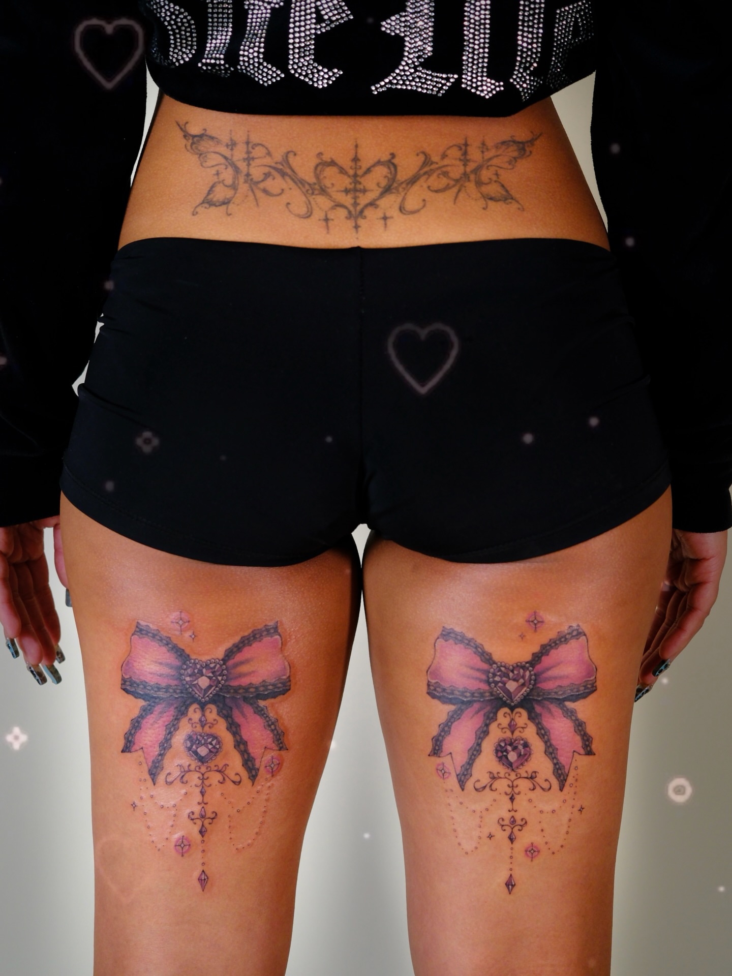 Bow and heart black and grey tattoo on the thigh by ââŪ. Ý ðķðð―ððð âðĶđËâ seattle tattoo artist, Seattle, Washington