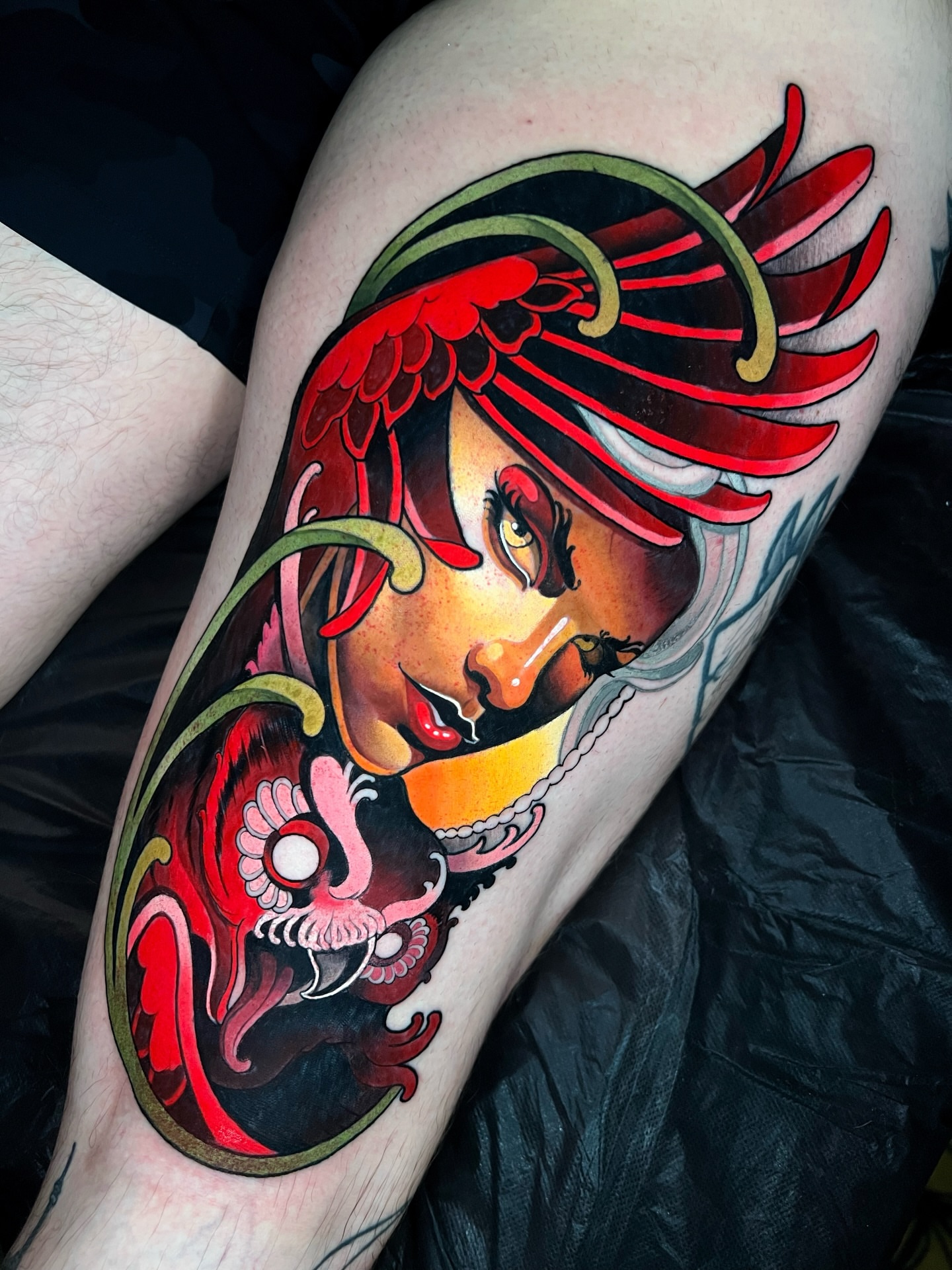 Woman with dragon American traditional tattoo on the thigh by Skyler Miller