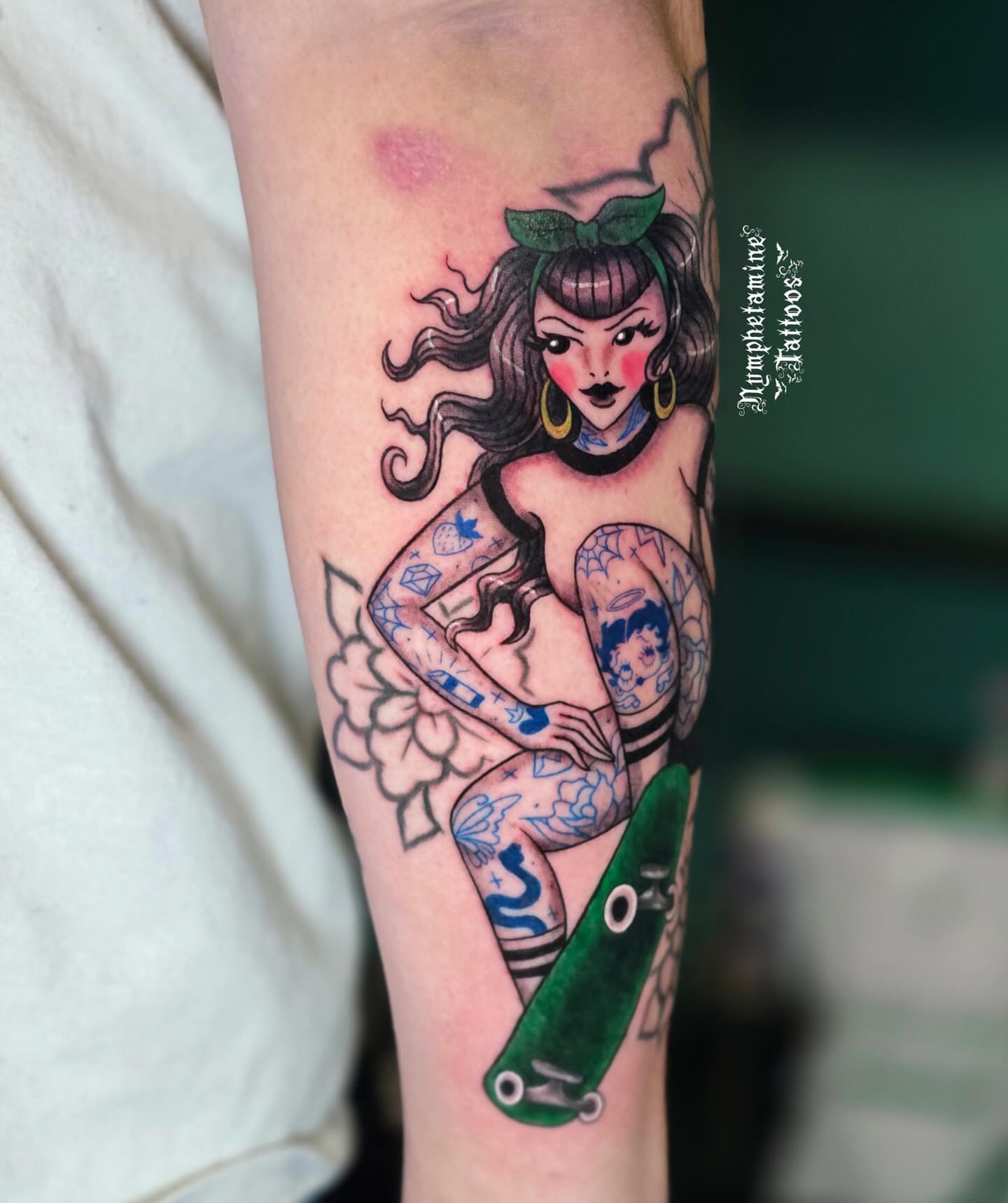 Skateboarding pin-up girl American traditional tattoo on the forearm by ๐ธ๐๐๐๐๐๐๐๐