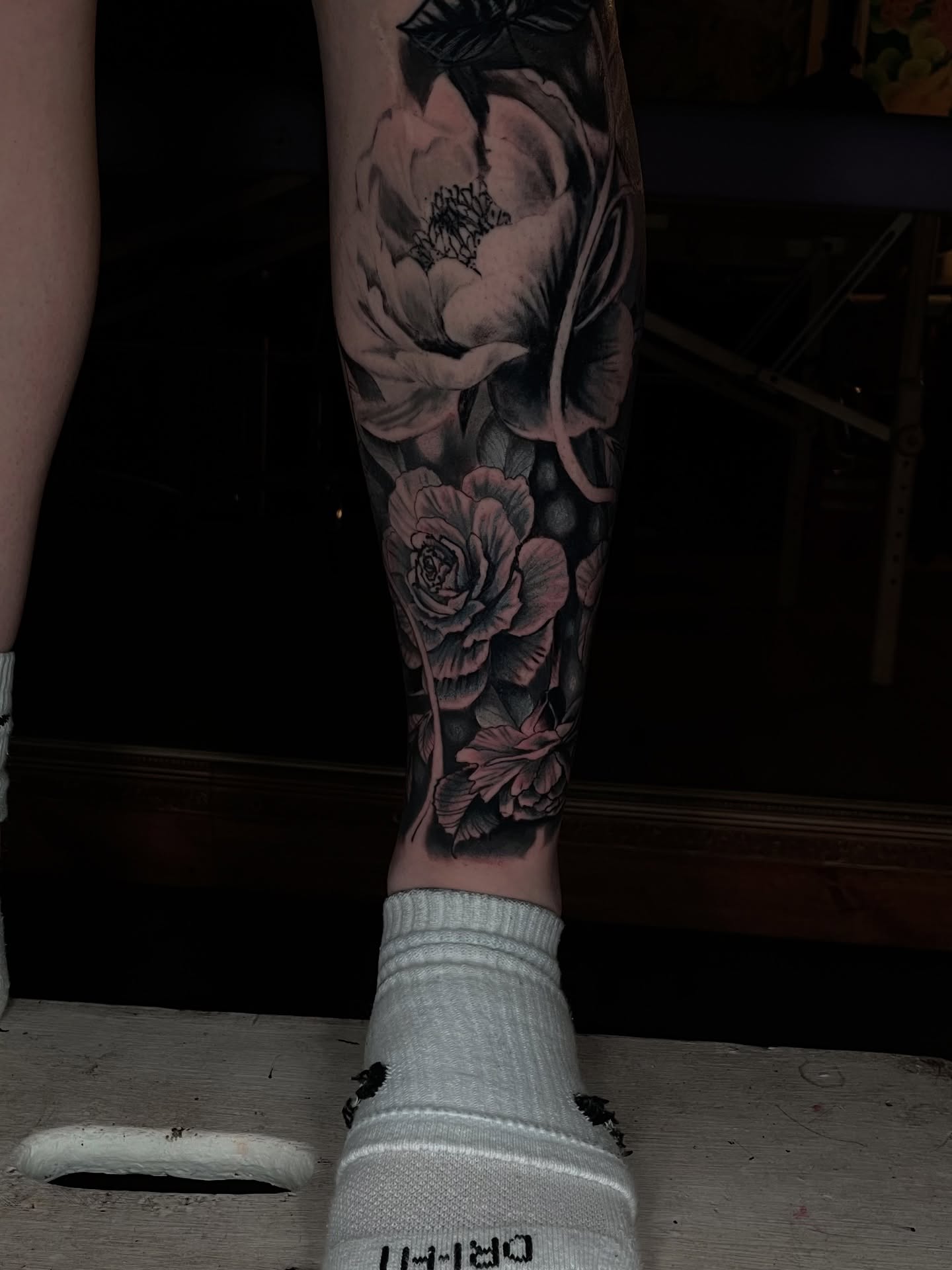 Flowers realism tattoo on the calf by Dean Rogers