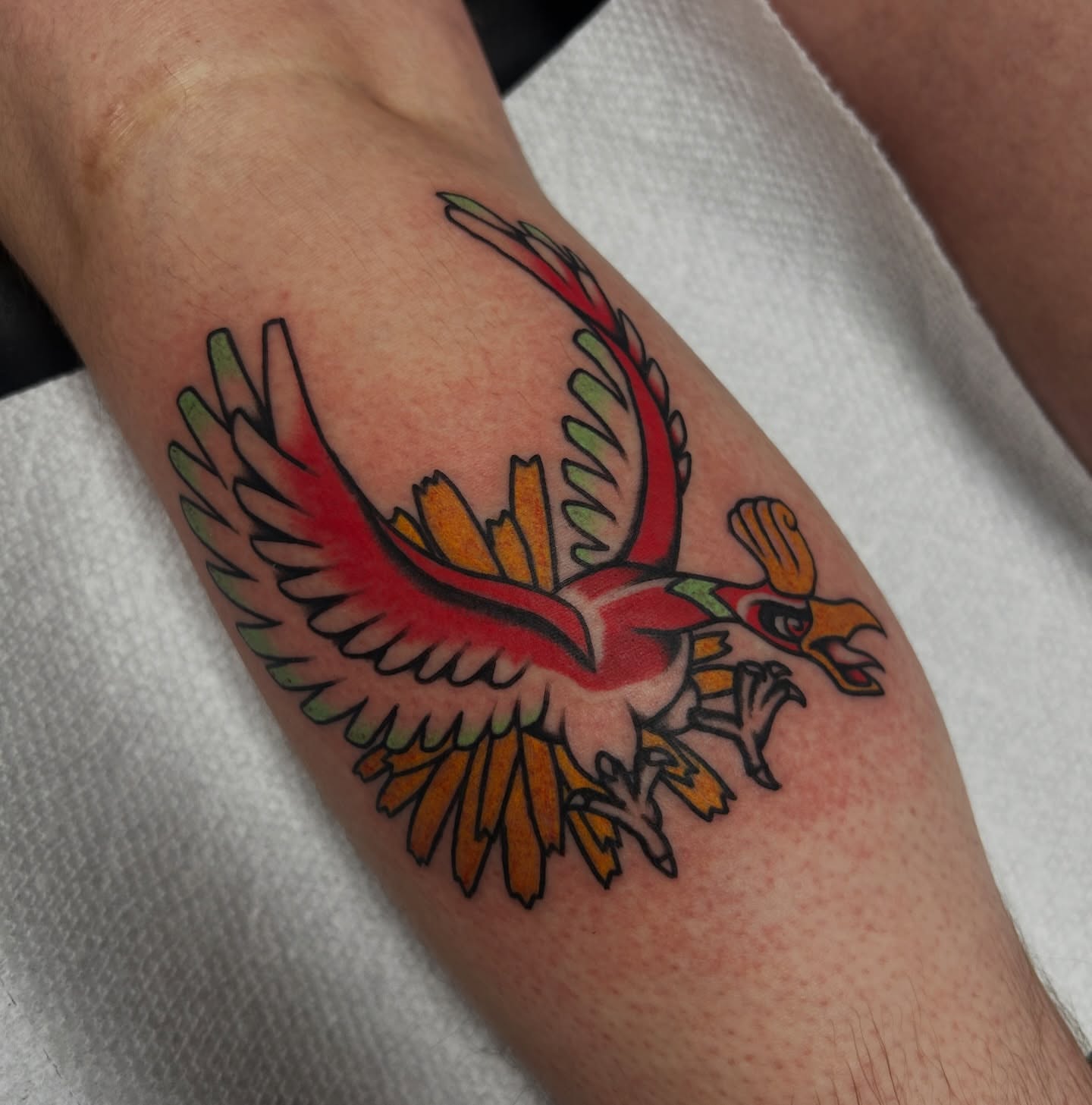 Phoenix American traditional tattoo on the forearm by Dylan James