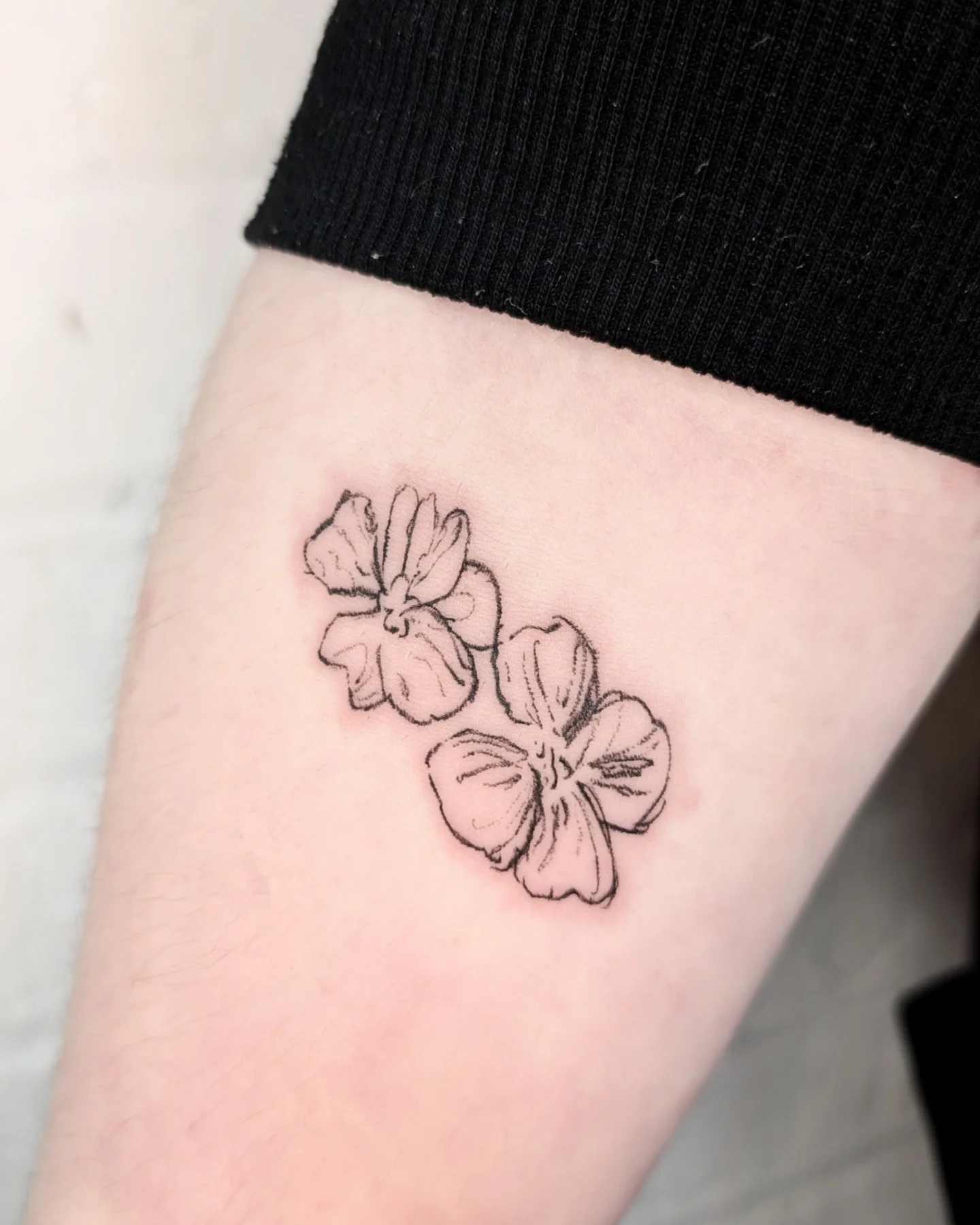 Hibiscus flowers black and grey tattoo on the forearm by mila