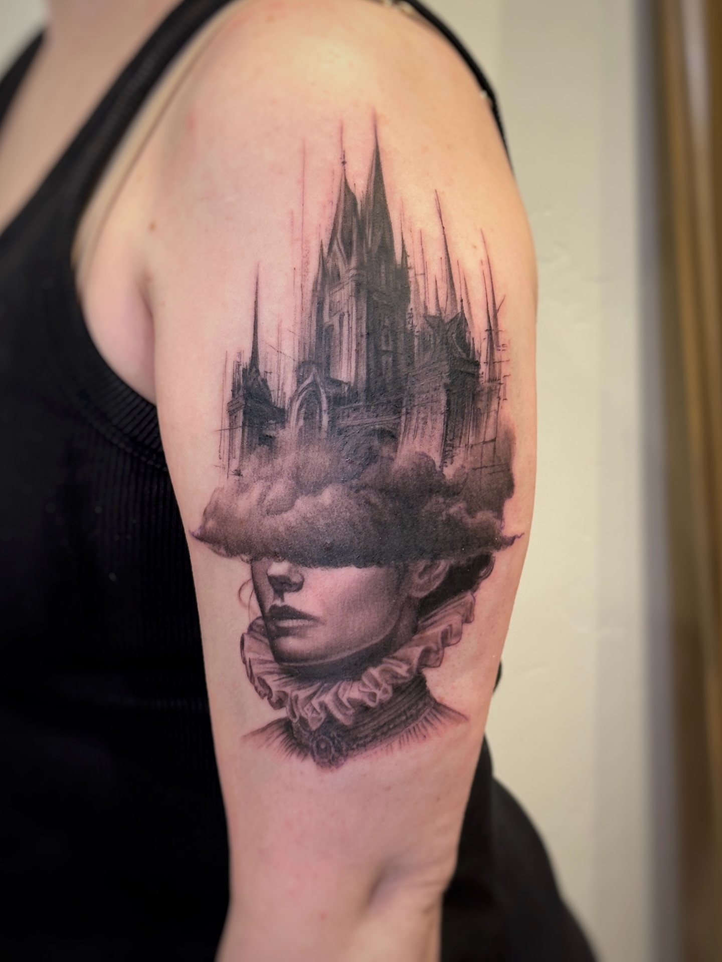 Castle in cloud dark realism tattoo on the shoulder by Paige Jean