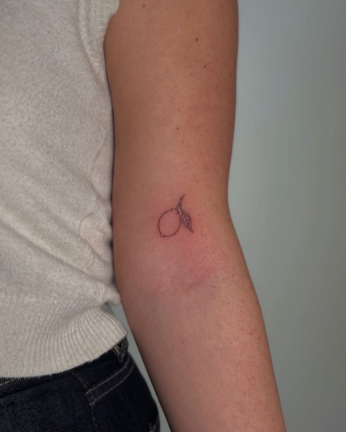 Lemon fine line tattoo on the forearm by Jules Ink ⋆ Fineline Tattoo