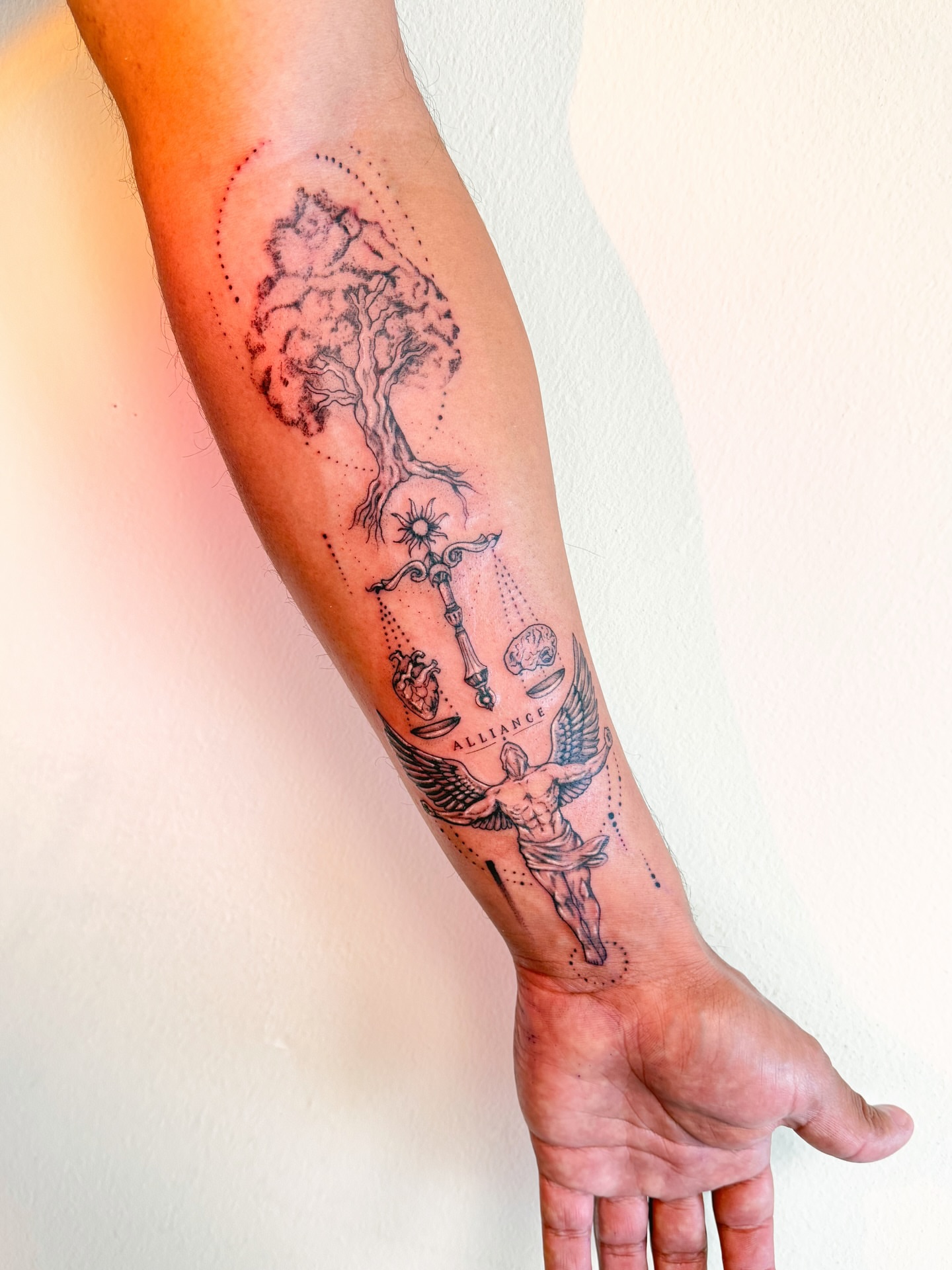 Tree and angel dotwork tattoo on the forearm by Tatuajes Denver