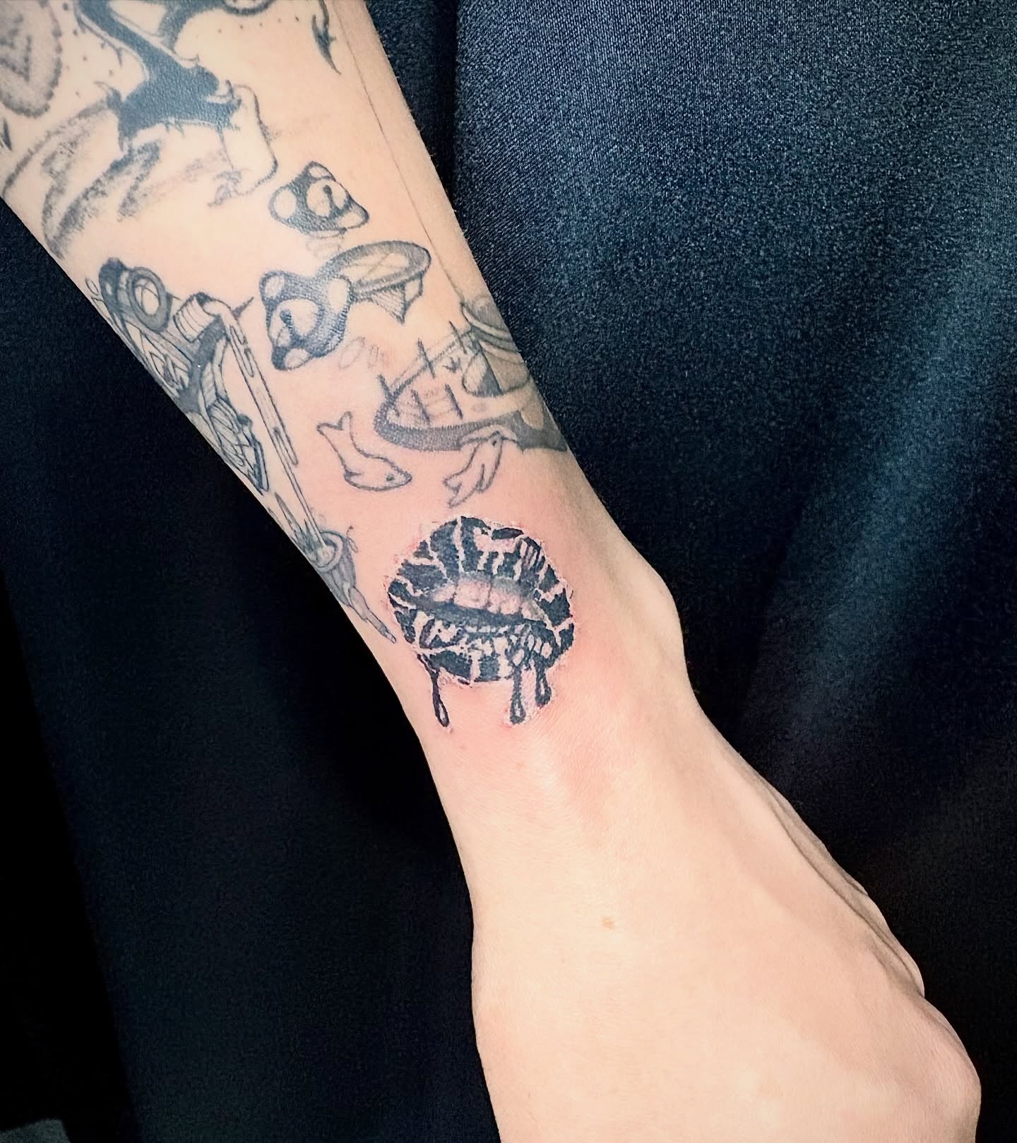 Lips black and grey tattoo on the forearm by Rami, Maden🇰🇷