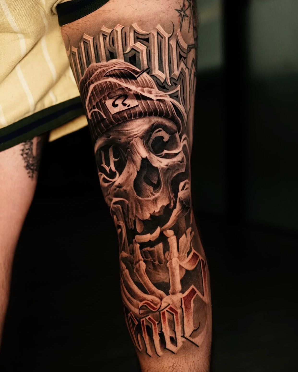 Skull and bones realism tattoo on the forearm by Lettering