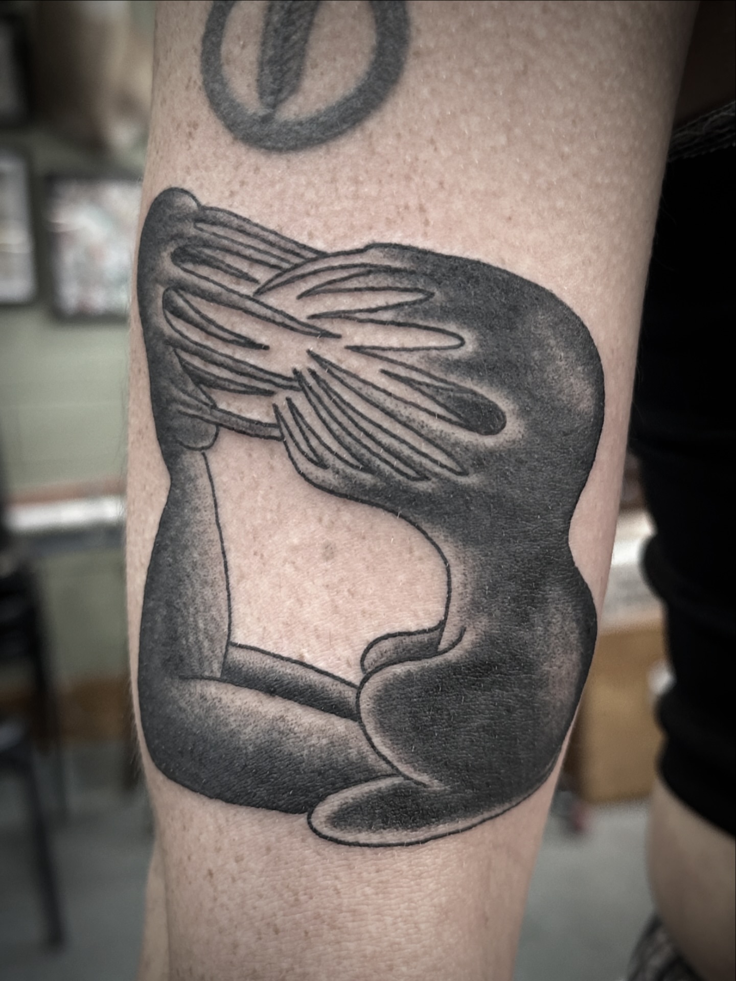 Abstract figure black and grey tattoo on the forearm by Chris Blanchard