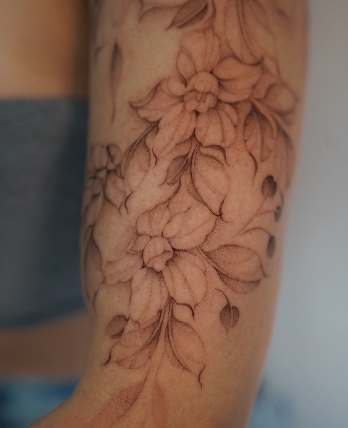 Floral arrangement black and grey tattoo on the forearm by Bel Fernandez