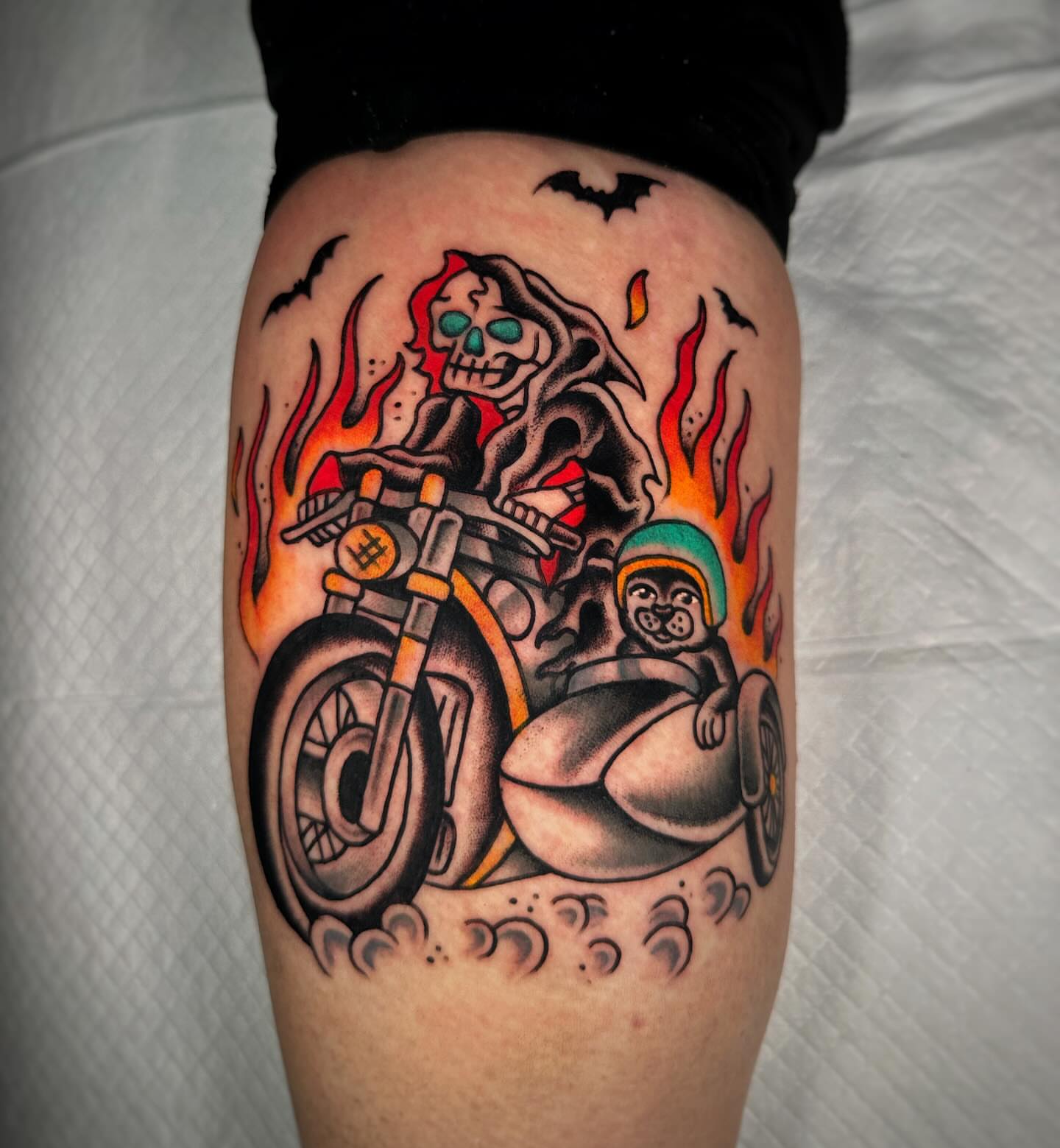 Motorcycle rider with monkey sidecar American traditional tattoo on the thigh by Alex Finnerty, Reading, Massachusetts