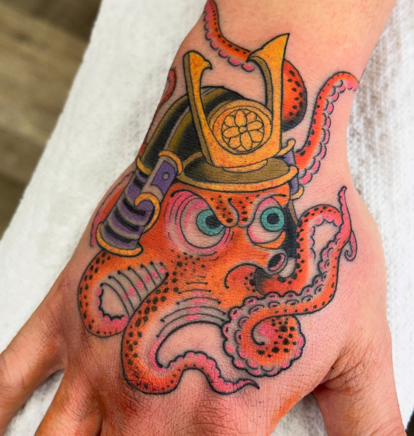 Octopus samurai helmet American traditional tattoo on the hand by Chris Orta