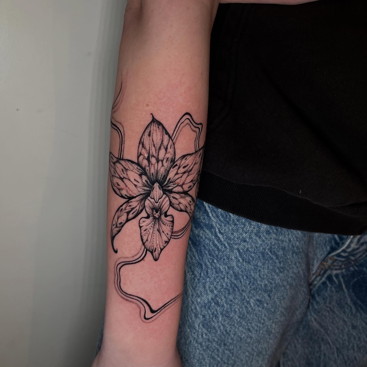 Orchid black and grey tattoo on the forearm by Elisa