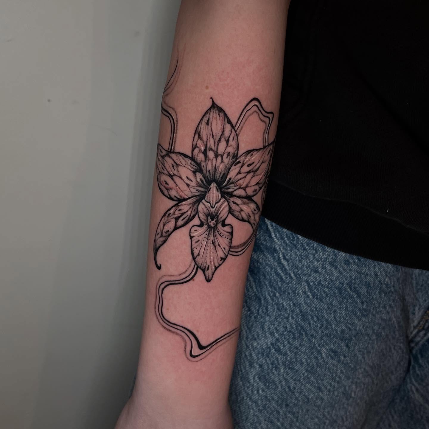Orchid black and grey tattoo on the forearm by Elisa