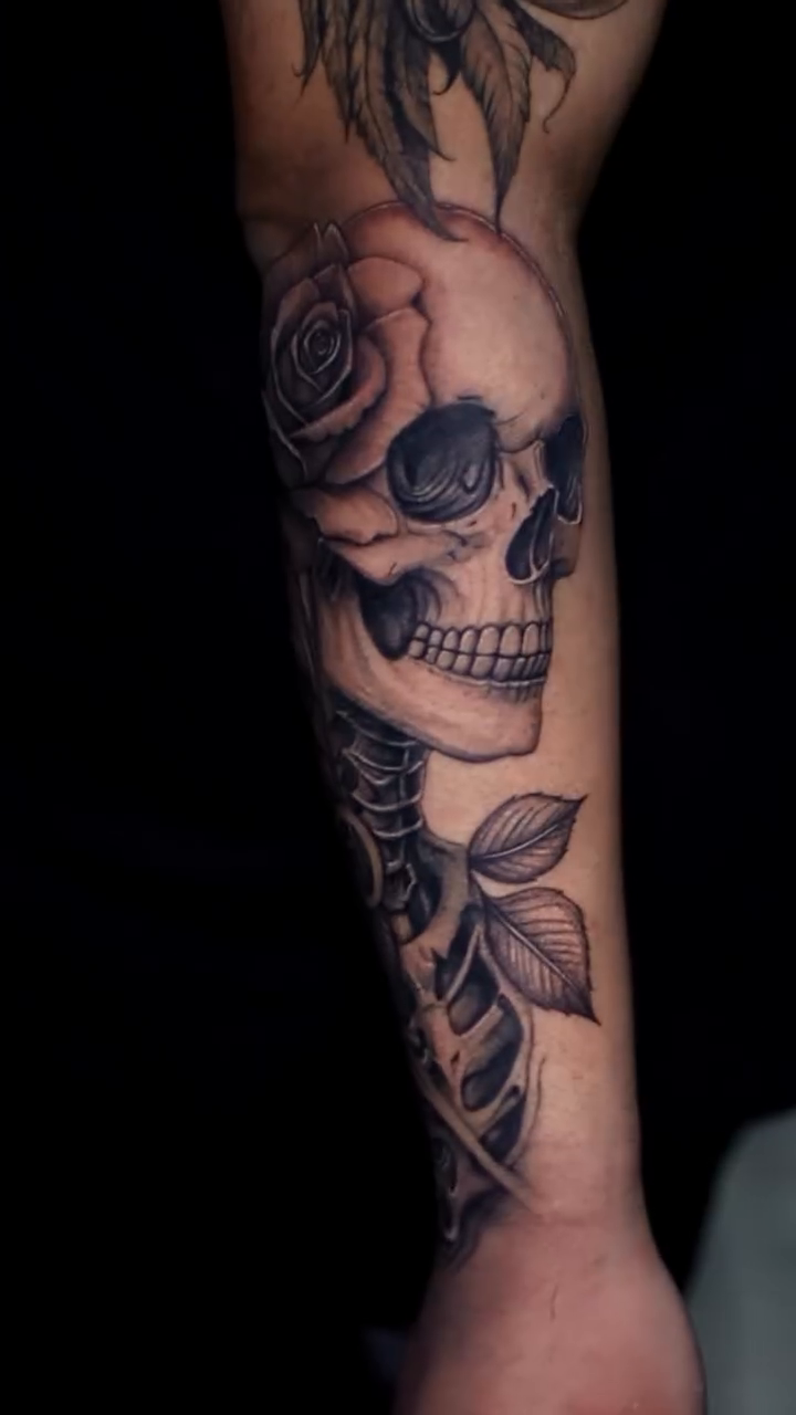Skull and rose realism tattoo on the forearm by 𝐒𝐡𝐞𝐫𝐥𝐥𝐲