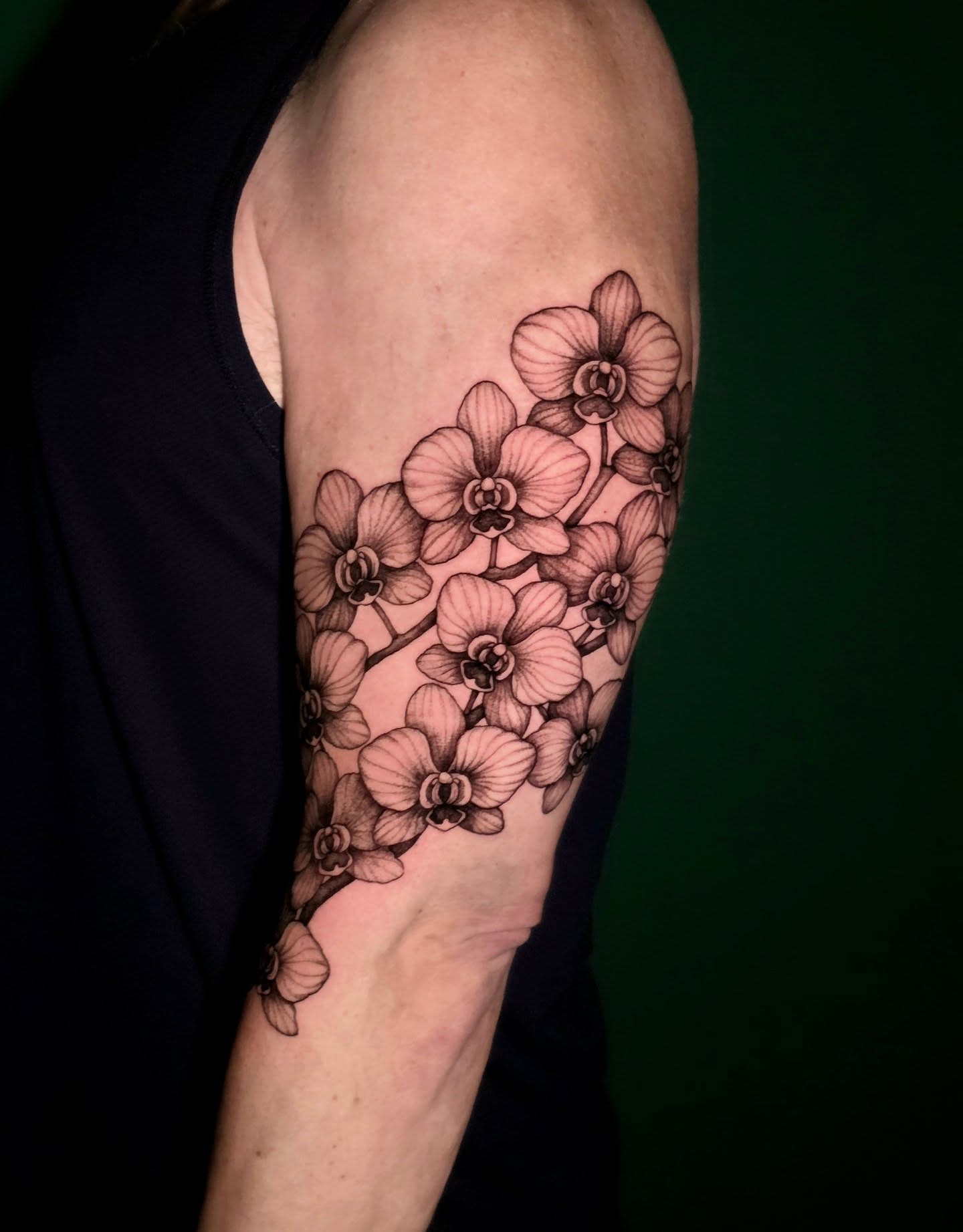 Orchids black and grey tattoo on the forearm by Nick de Hoyos