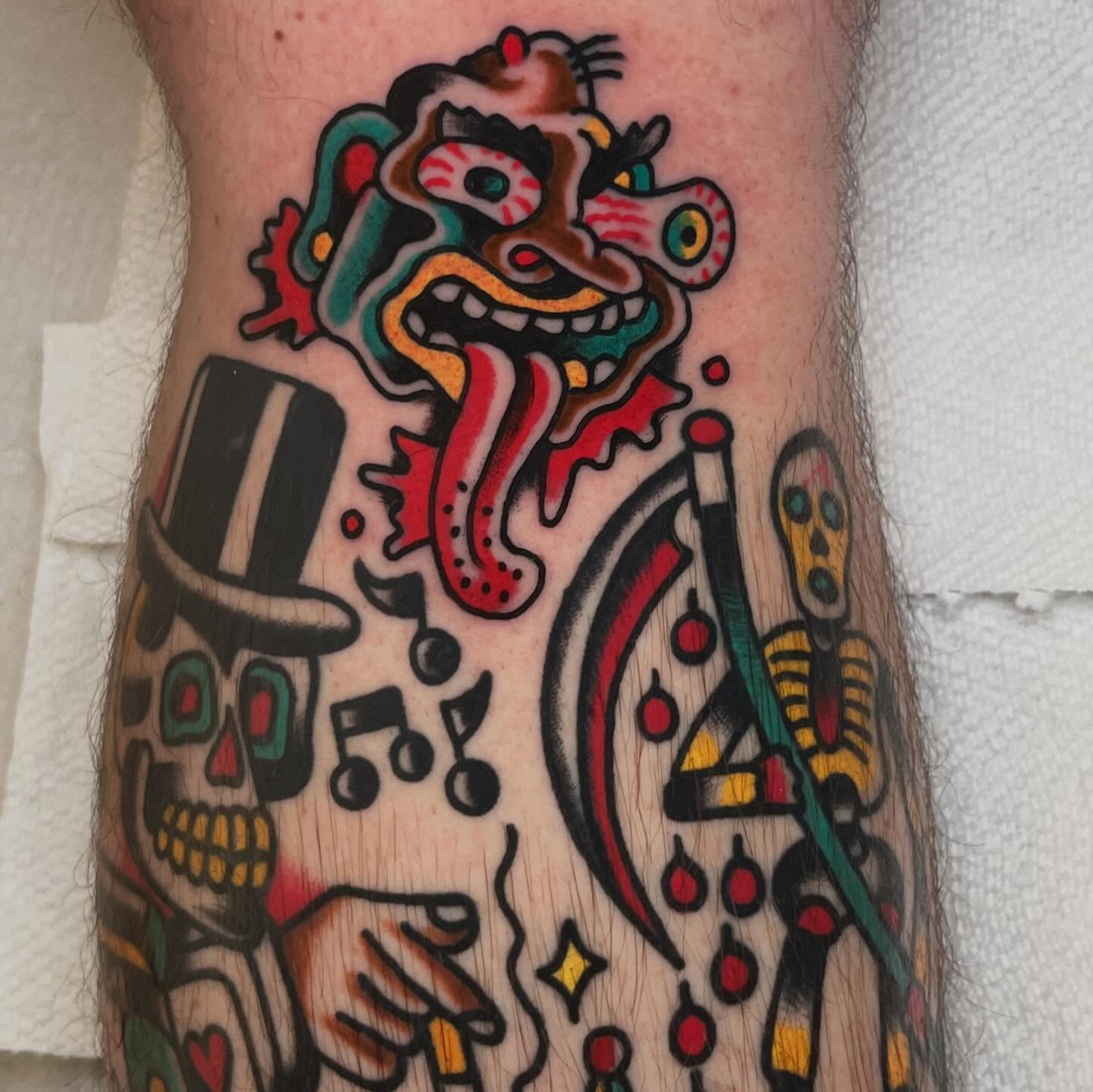 Clown and skull American traditional tattoo on the forearm by Rizzo