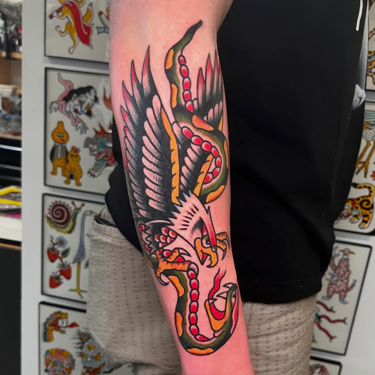 Snake and wings American traditional tattoo on the forearm by Rizzo