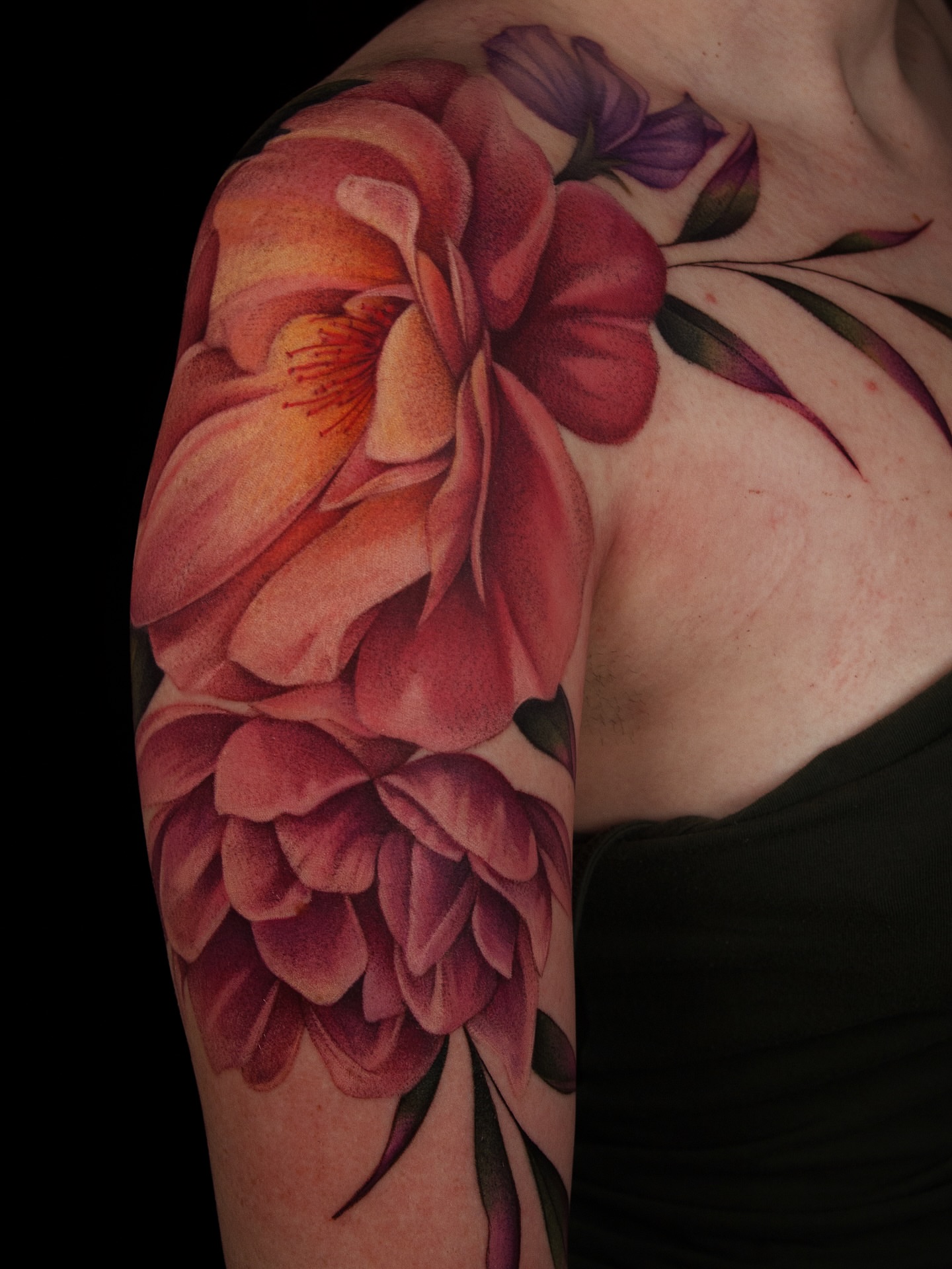 Floral arrangement realism tattoo on the upper arm by caliope yiannos