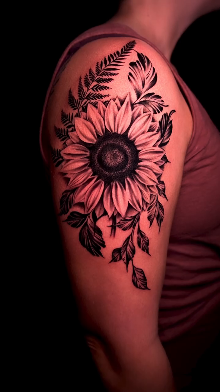 Sunflower and fern realism tattoo by Greg Petrali