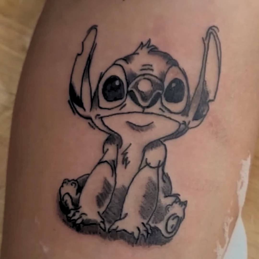 Stitch character new school tattoo on the thigh by MY$T