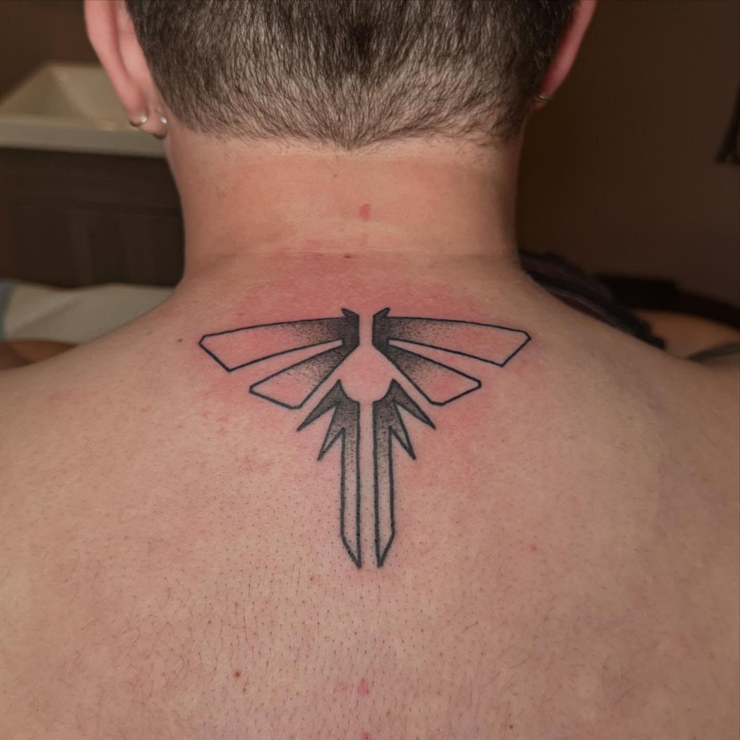 Geometric symbol dotwork tattoo on the back by zoie rozay hannah