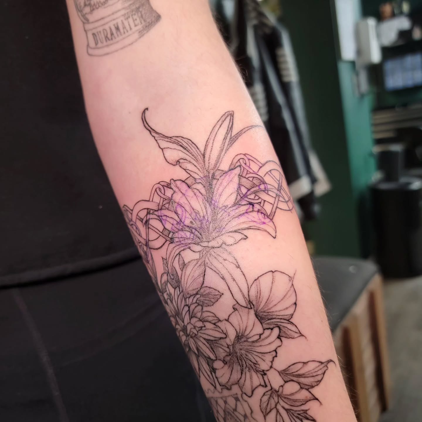 Floral arrangement black and grey tattoo on the forearm by Nathan Harkins-Oberbeck