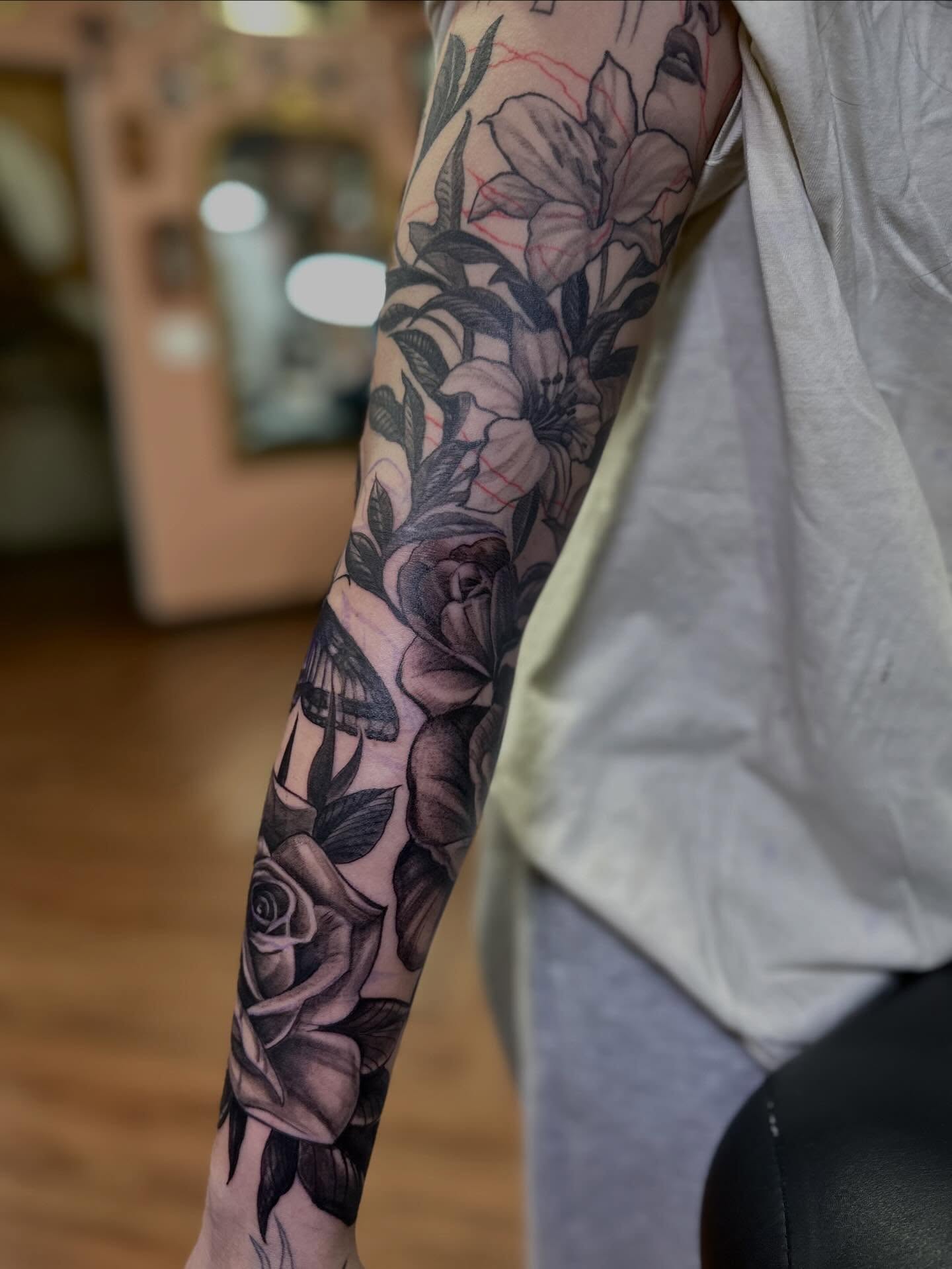 Floral bouquet black and grey tattoo on the forearm by Mathilda Quynh