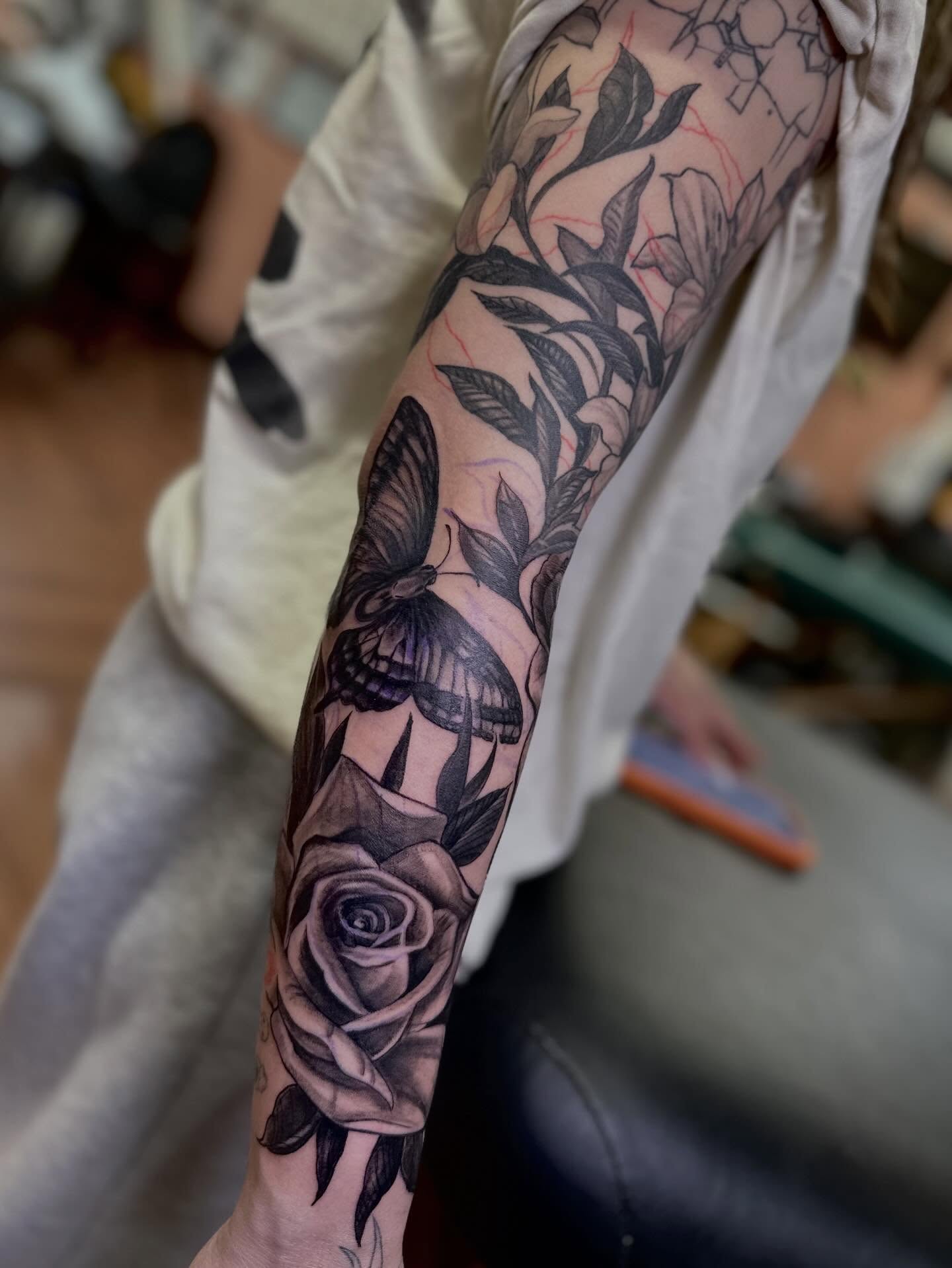 Butterfly and roses realism tattoo on the forearm by Mathilda Quynh