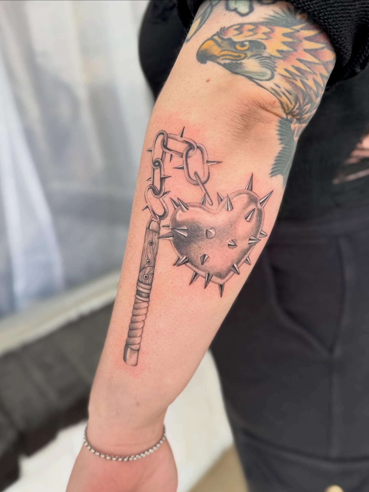 Heart with spikes black and grey tattoo on the forearm by Lily Cuoio~ Seattle