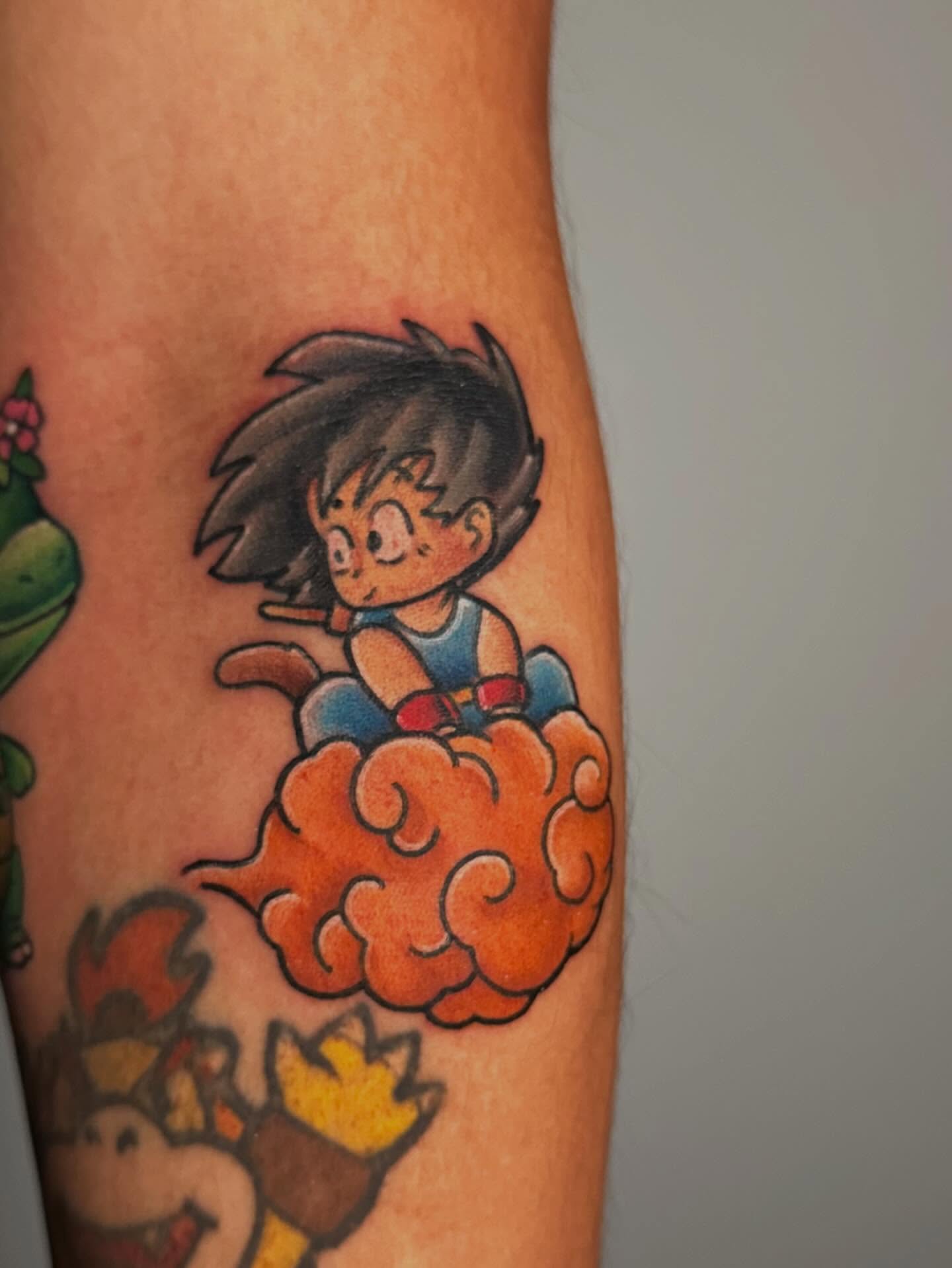 Goku flying on a cloud anime tattoo on the forearm by Chi, Charlotte, North Carolina
