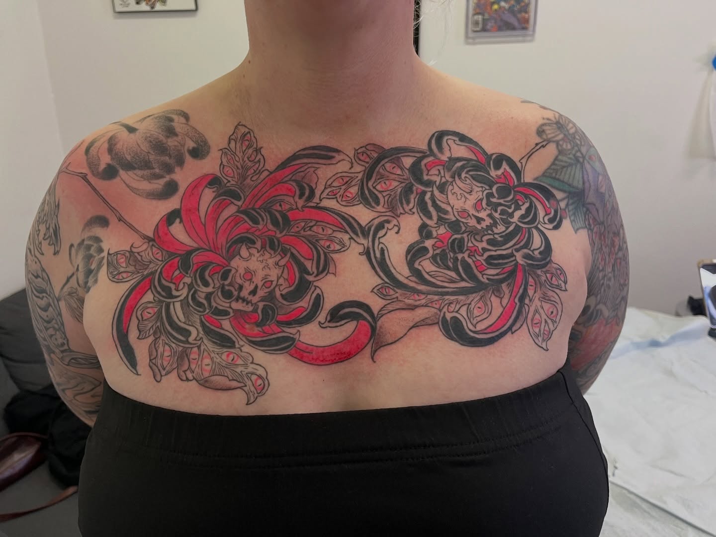 Chrysanthemum and demon japanese irezumi tattoo on the chest by Lacey B, Portland, Oregon