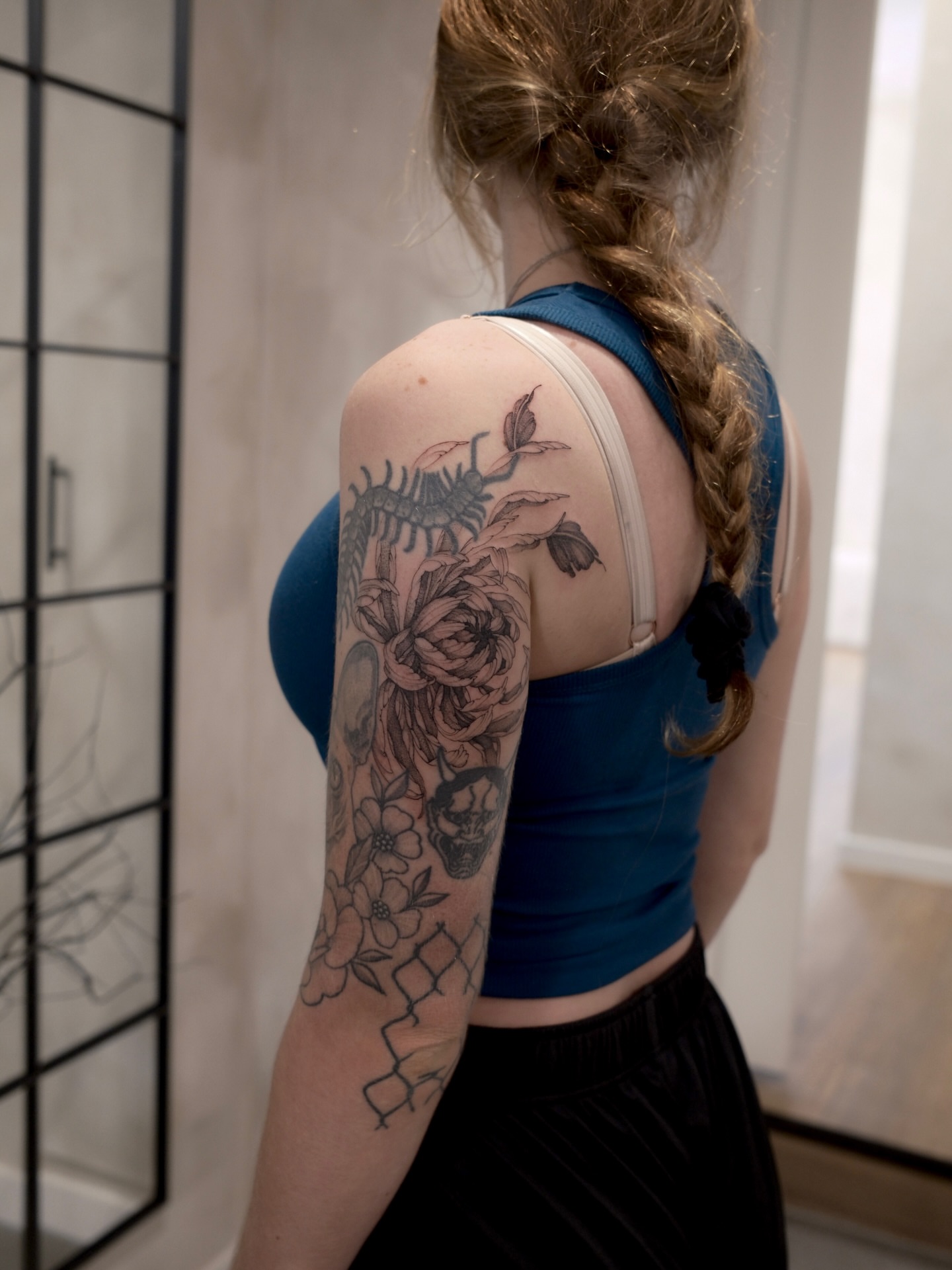 Scorpion and flowers realism tattoo on the upper arm by Joy, Gold Coast, Queensland