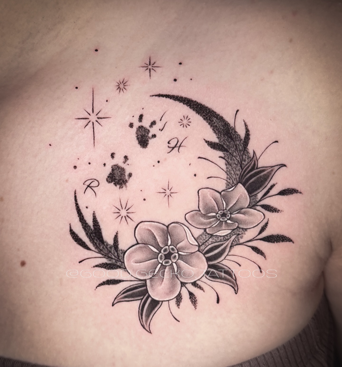 Moon, flowers, handprints, stars dotwork tattoo on the chest by Gecko