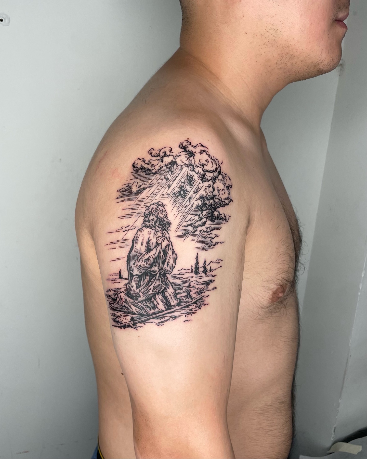 Religious scene realism tattoo on the shoulder by Anh Đan