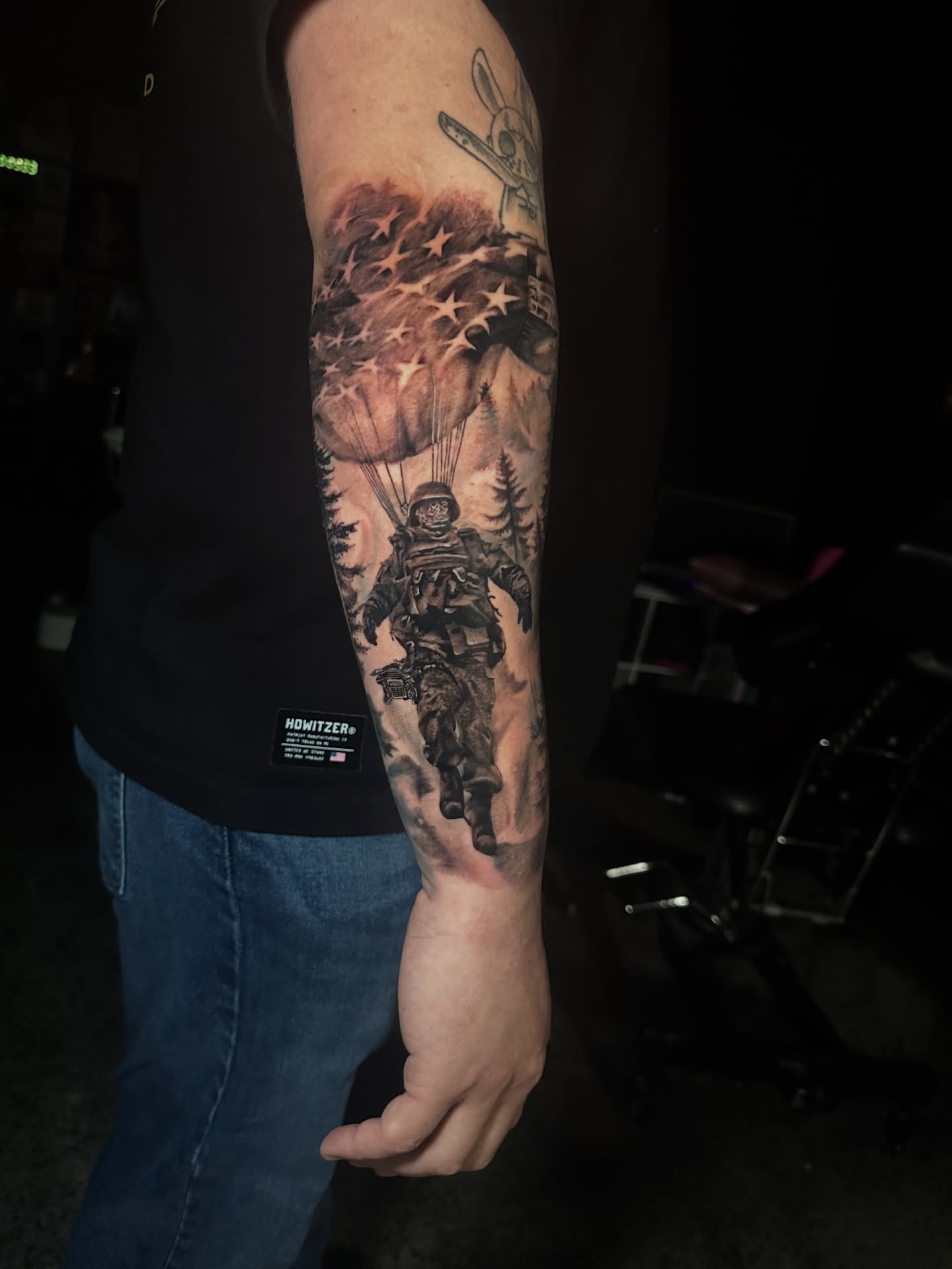 Paratrooper with American flag realism tattoo on the forearm by Elizabeth’s Eclectic Tattoos