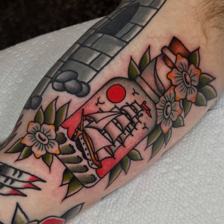 Ship and flowers American traditional tattoo on the forearm by Kyle Logan Frary
