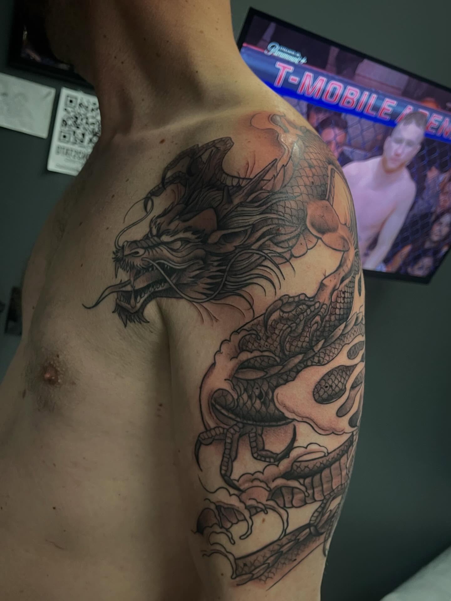 Dragon with flames Japanese tattoo on the shoulder by Chris Torres