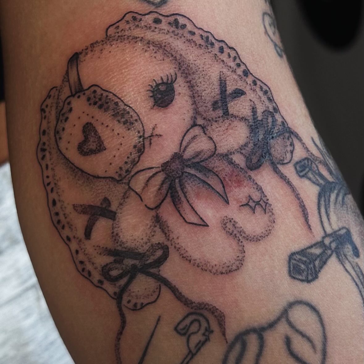 Teddy bear dotwork tattoo on the forearm by Maddie Neibert