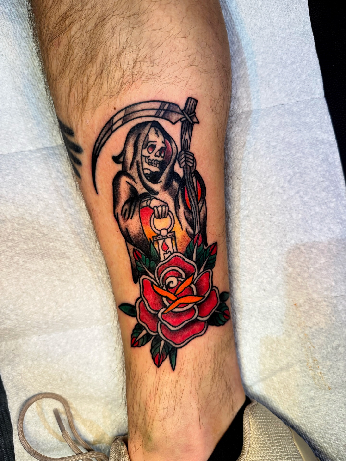 Grim reaper with rose American traditional tattoo on the forearm by Ericka Hampton, Ferndale, Michigan