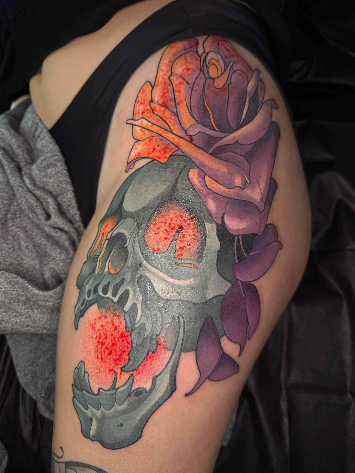 Skull and rose American traditional tattoo on the shoulder by Anne Cornelson
