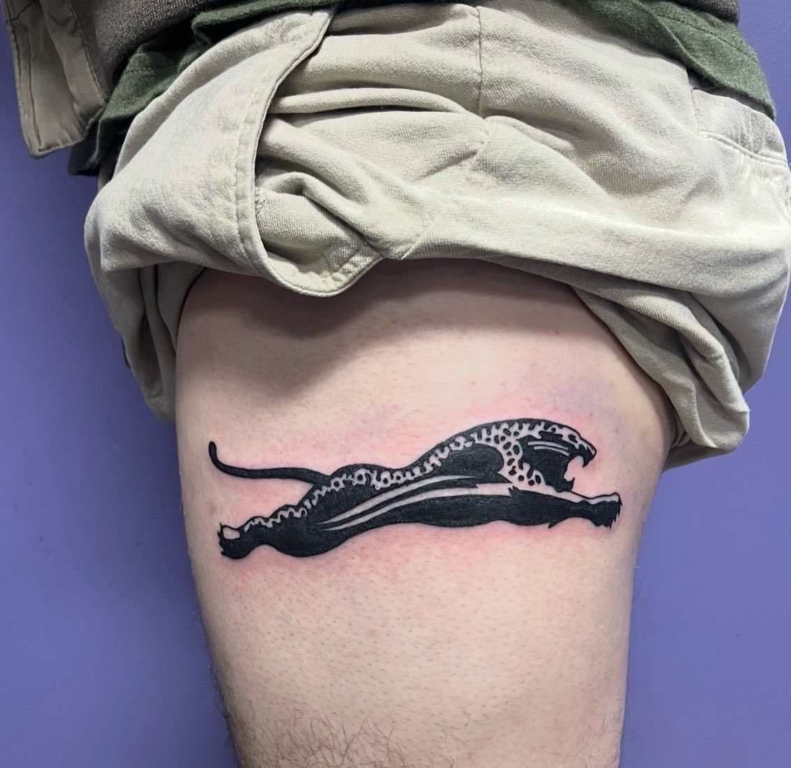 Leopard black and grey tattoo on the thigh by Mark Calloway
