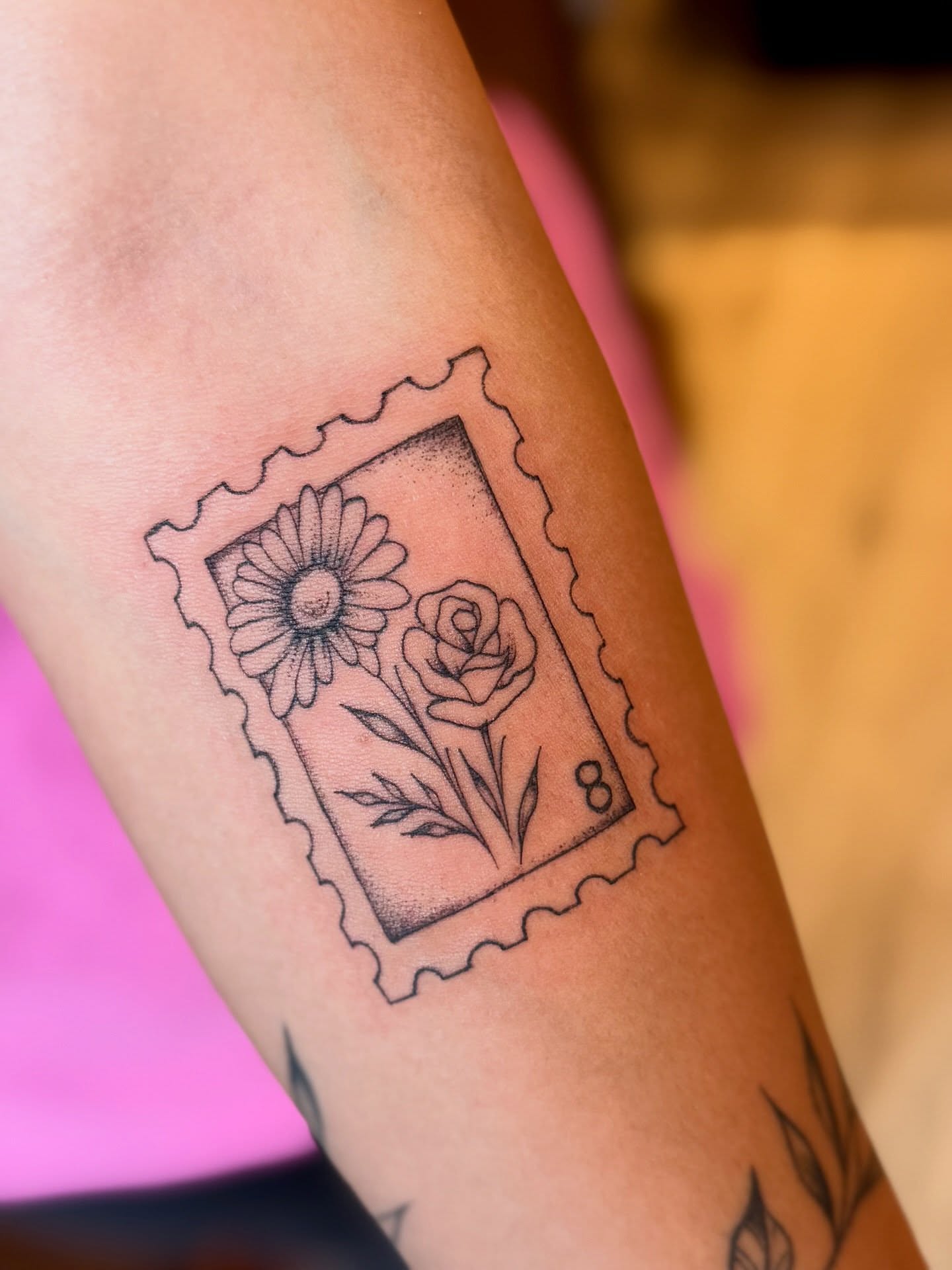 Flower postage stamp dotwork tattoo on the forearm by Emily Velletta, Huntersville, North Carolina