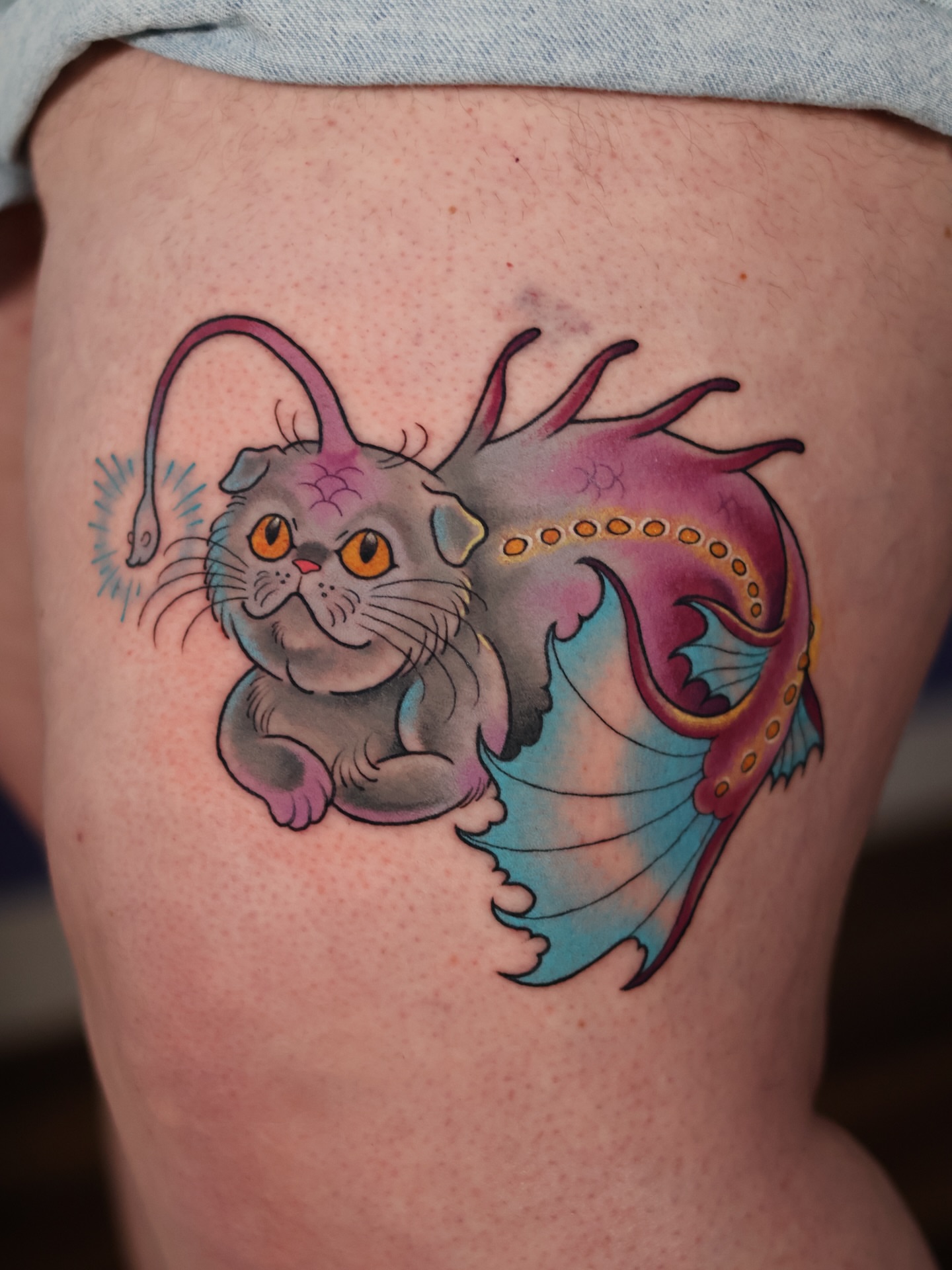 Cat and dragon new school tattoo on the thigh by Sarah Baldwin