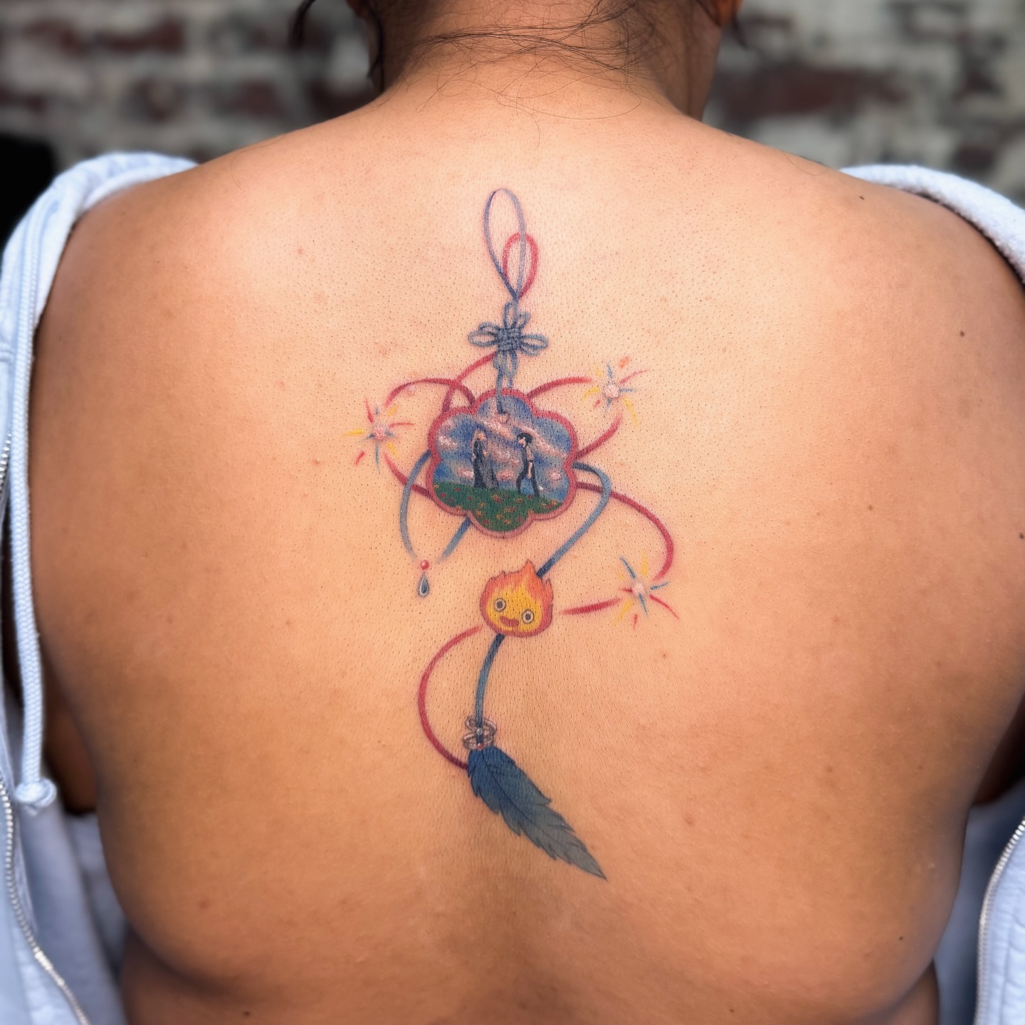Chinese knot with celestial elements dotwork tattoo on the back by justin
